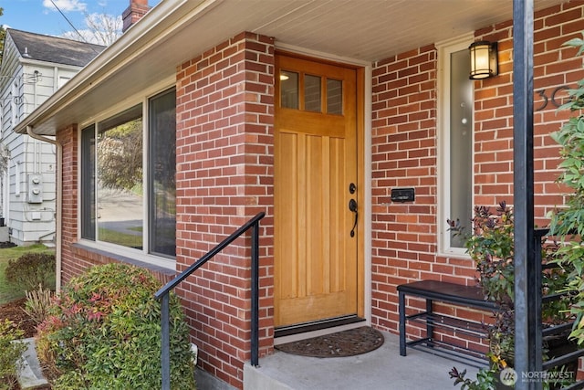 property entrance featuring brick siding