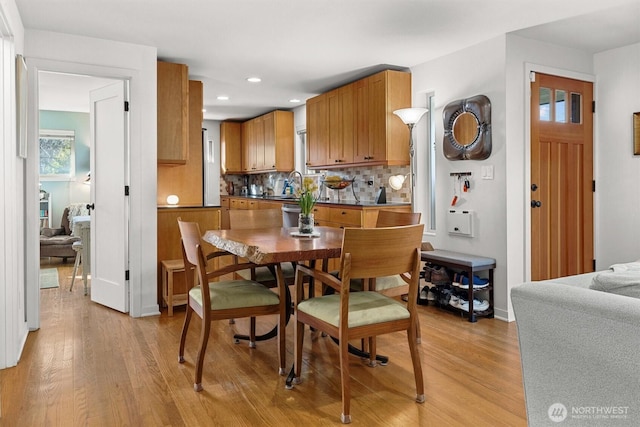 dining space with recessed lighting, baseboards, and light wood finished floors