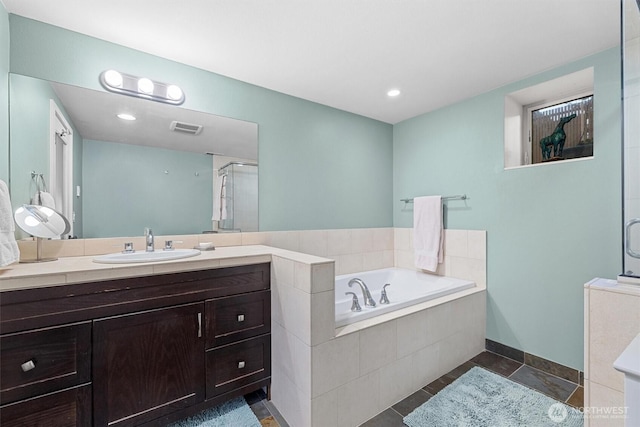 bathroom featuring a garden tub, visible vents, vanity, a shower stall, and tile patterned floors