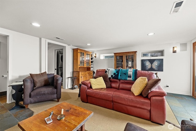 living room with baseboards, visible vents, and recessed lighting