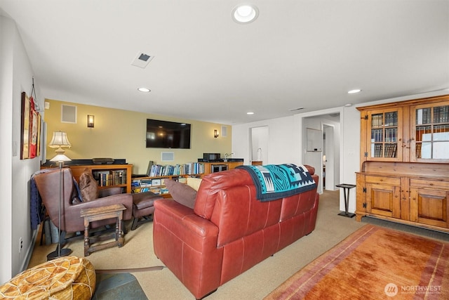 living area with carpet, visible vents, and recessed lighting