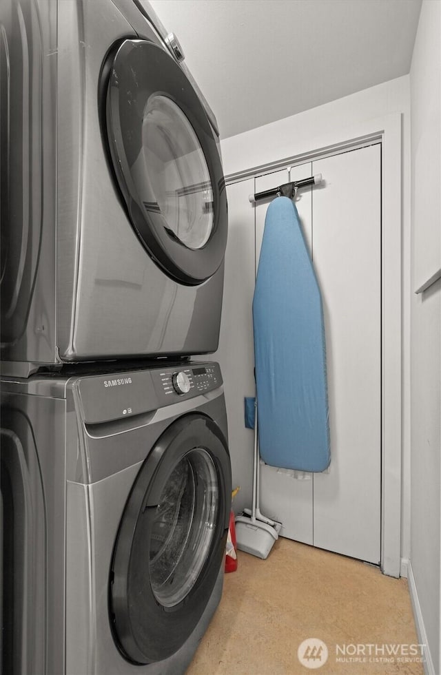 washroom featuring laundry area and stacked washer / dryer