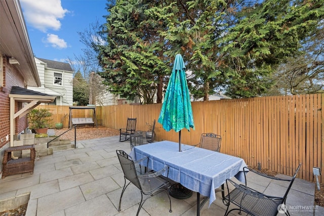 view of patio featuring a fenced backyard and outdoor dining space