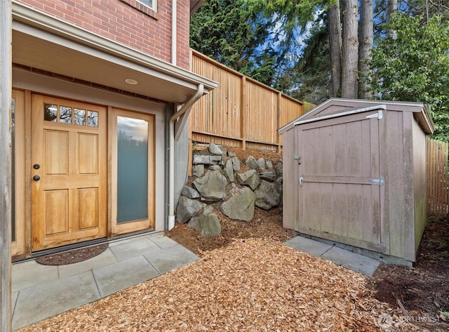 view of shed featuring fence