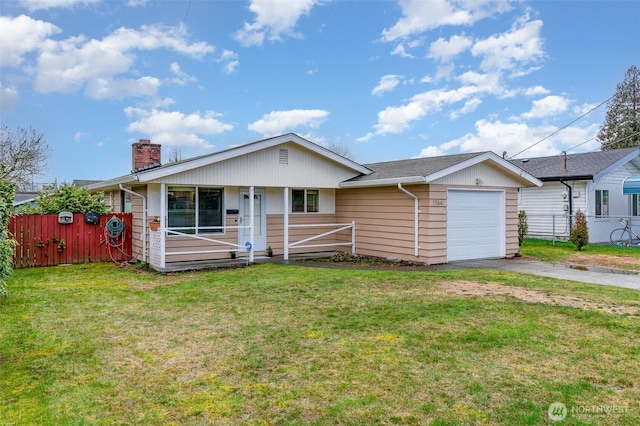 view of front facade featuring a garage, driveway, a front lawn, and fence