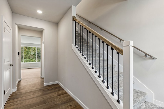 stairs with recessed lighting, baseboards, and wood finished floors