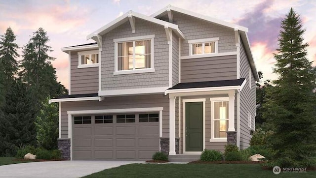 craftsman-style house with a garage, concrete driveway, and stone siding