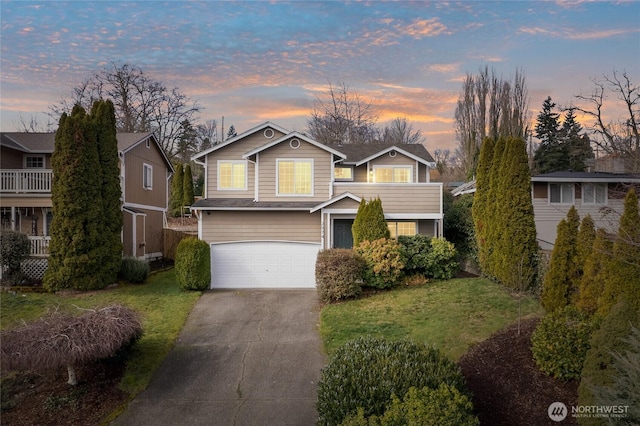 view of front of house with a garage, concrete driveway, and a front lawn