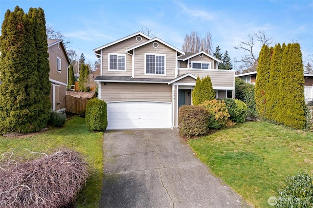 traditional home featuring a front yard, driveway, an attached garage, and fence