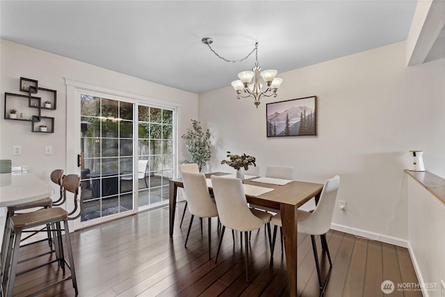 dining room featuring baseboards, dark wood finished floors, and an inviting chandelier