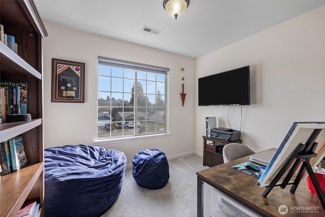 office space featuring carpet floors, visible vents, and baseboards