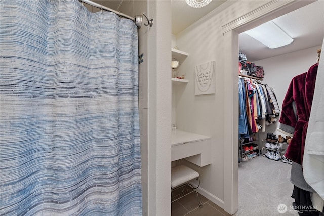 bathroom featuring tile patterned flooring, a shower with shower curtain, and baseboards