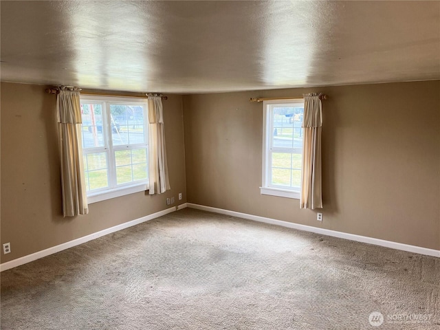 spare room with carpet floors and baseboards