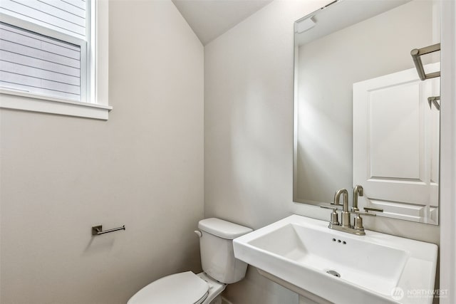 half bath featuring a sink and toilet