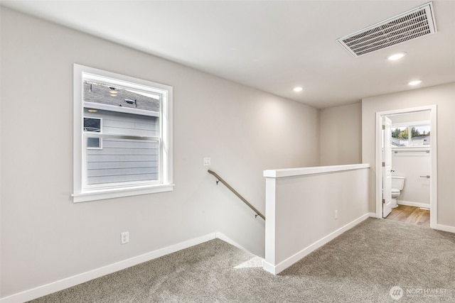 corridor with recessed lighting, visible vents, carpet flooring, an upstairs landing, and baseboards