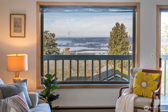 balcony with a water view and baseboard heating