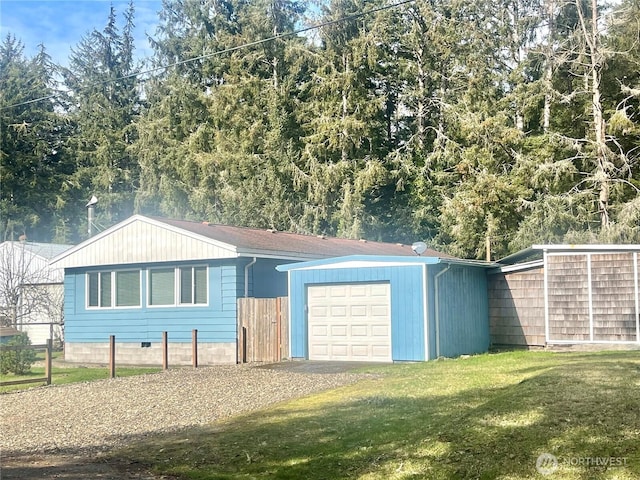 garage with fence and driveway