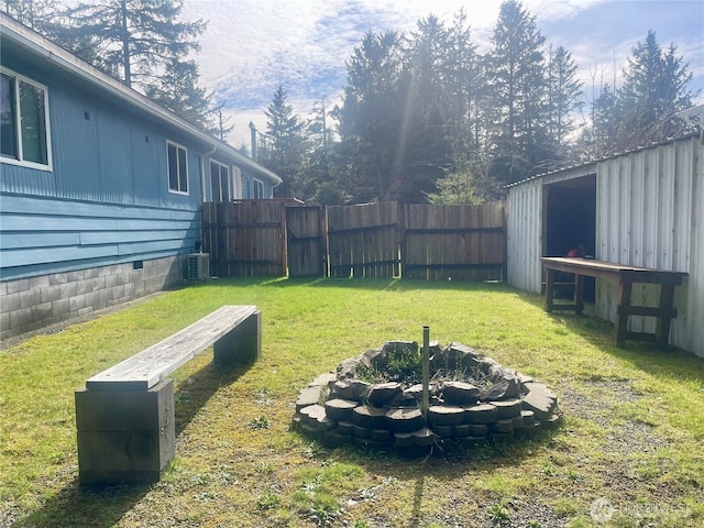 view of yard with a fenced backyard and central AC unit