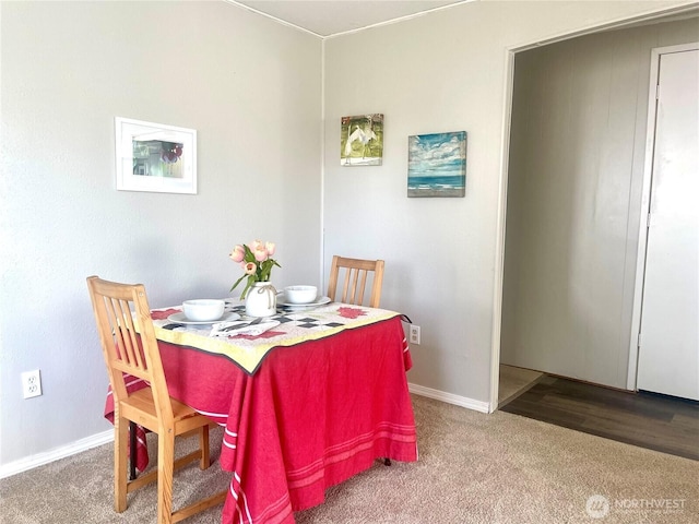 dining room with carpet and baseboards