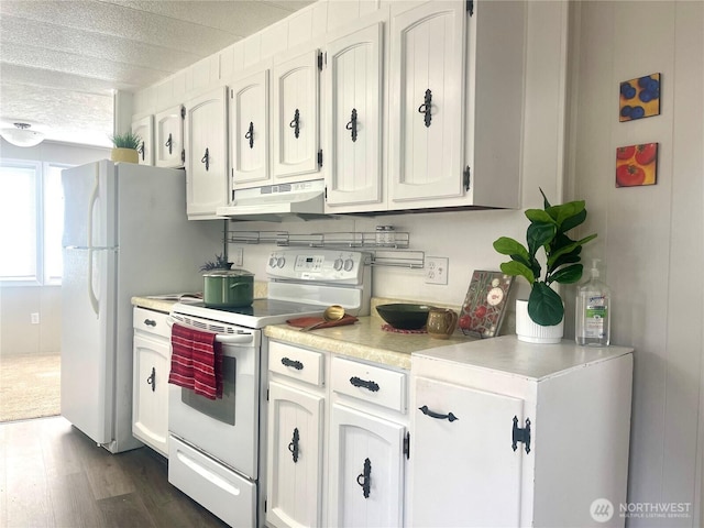 kitchen with dark wood finished floors, white electric range oven, light countertops, white cabinetry, and under cabinet range hood