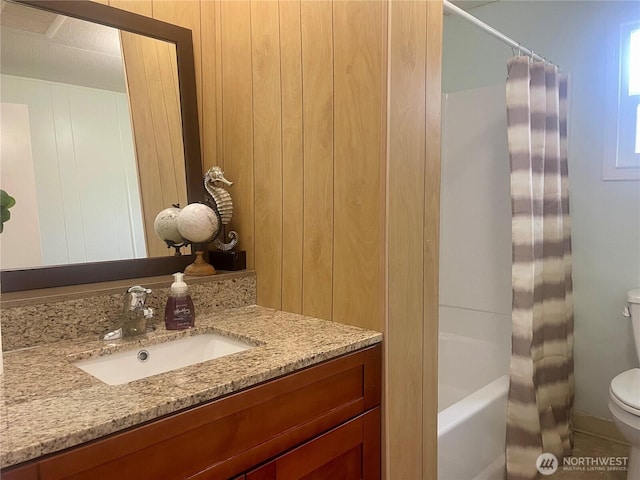 bathroom with shower / bath combination with curtain, vanity, and toilet