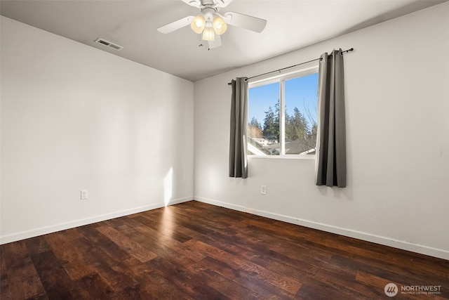 spare room with ceiling fan, wood finished floors, visible vents, and baseboards