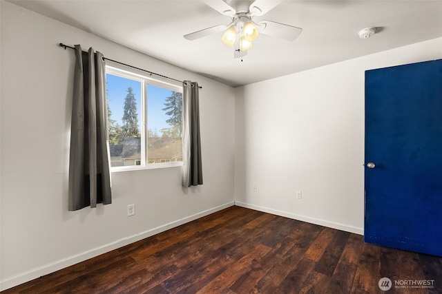 empty room with ceiling fan, wood finished floors, and baseboards