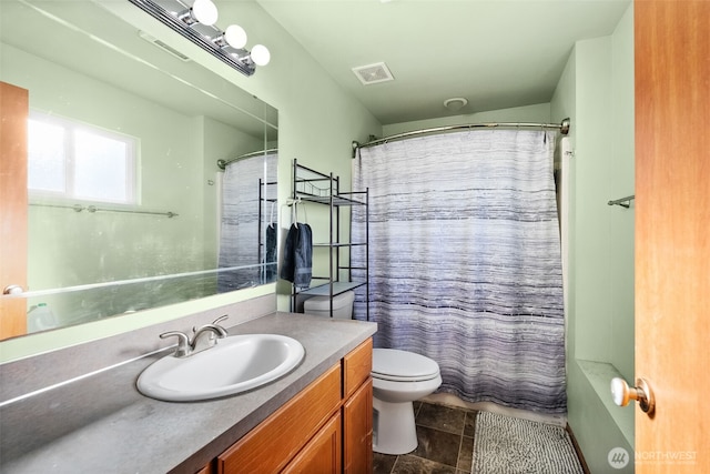 bathroom featuring toilet, visible vents, and vanity