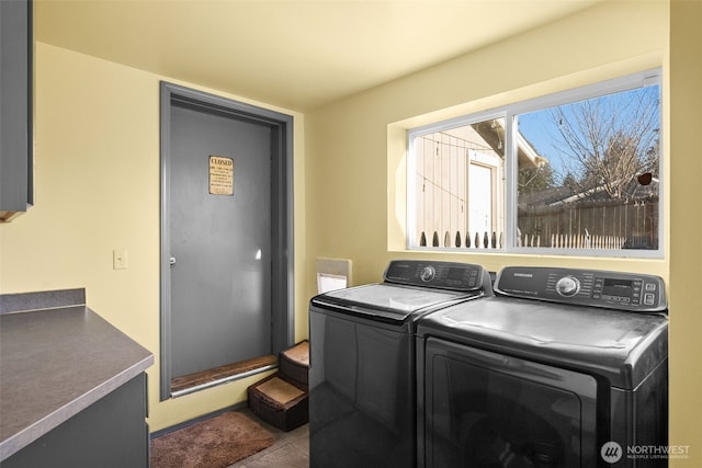 laundry room with tile patterned floors, laundry area, and separate washer and dryer