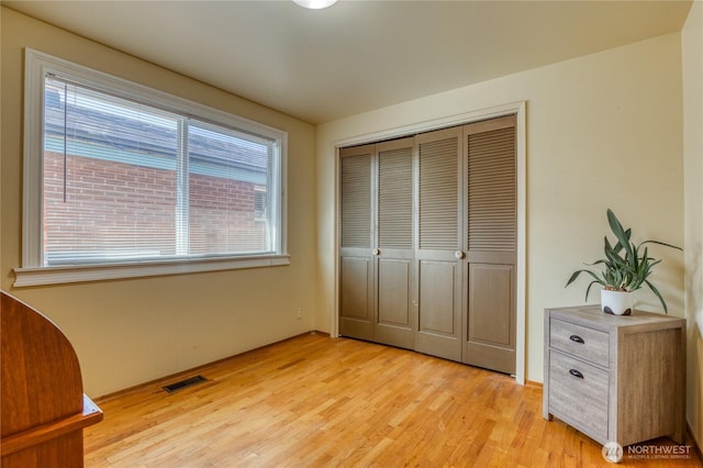10008 Rainier Ave S, Seattle, WA 98178 - unfurnished bedroom featuring light wood-style floors, a closet, and visible vents