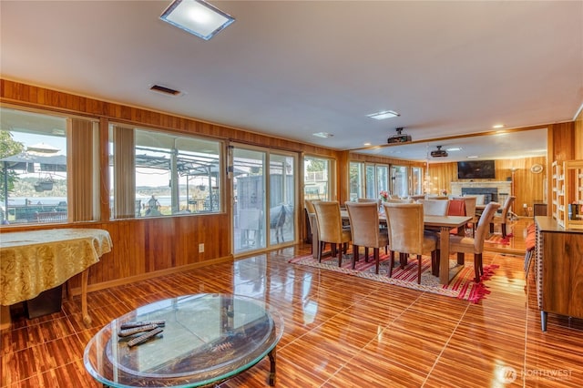 10008 Rainier Ave S, Seattle, WA 98178 - dining space featuring wooden walls, visible vents, and a large fireplace