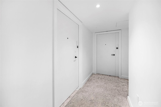 corridor featuring recessed lighting, light colored carpet, and baseboards