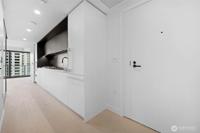 corridor with recessed lighting and light wood-type flooring