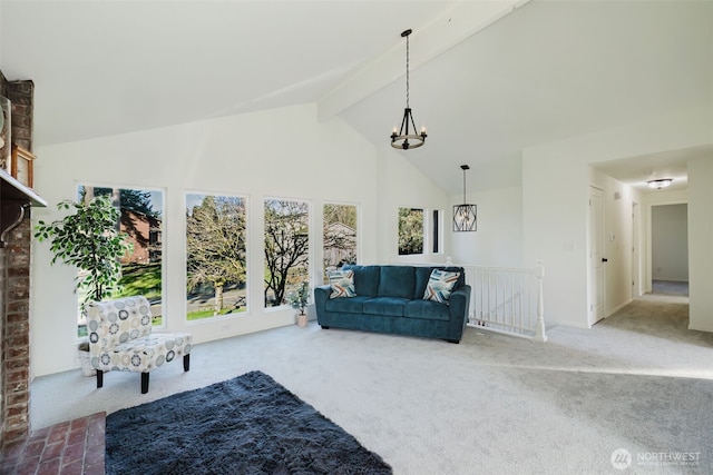 living room with carpet, beam ceiling, a notable chandelier, high vaulted ceiling, and baseboards