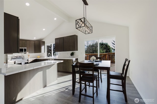 dining space featuring high vaulted ceiling, beamed ceiling, light wood-type flooring, and baseboards