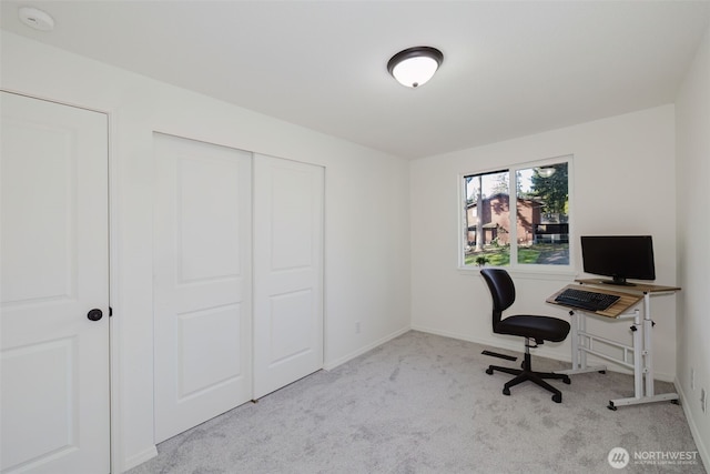 unfurnished office featuring carpet and baseboards