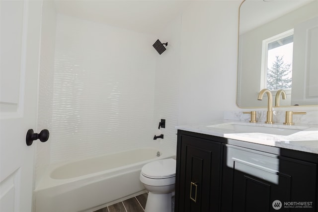 bathroom featuring toilet, bathtub / shower combination, wood finished floors, and vanity