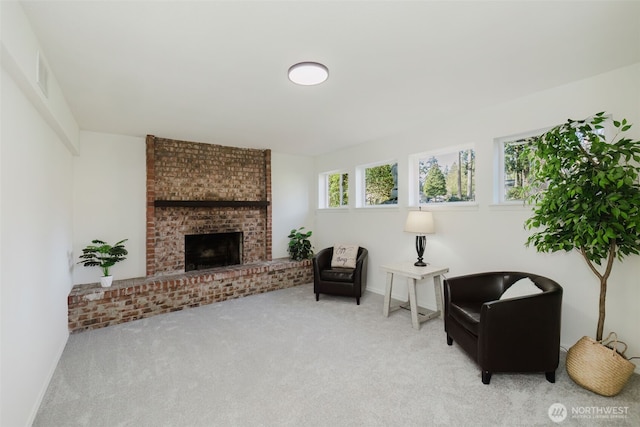 sitting room featuring carpet floors, visible vents, a fireplace, and baseboards