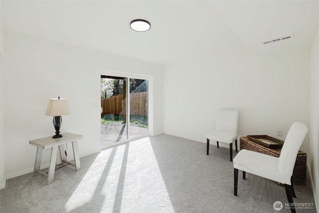 sitting room featuring carpet flooring and visible vents