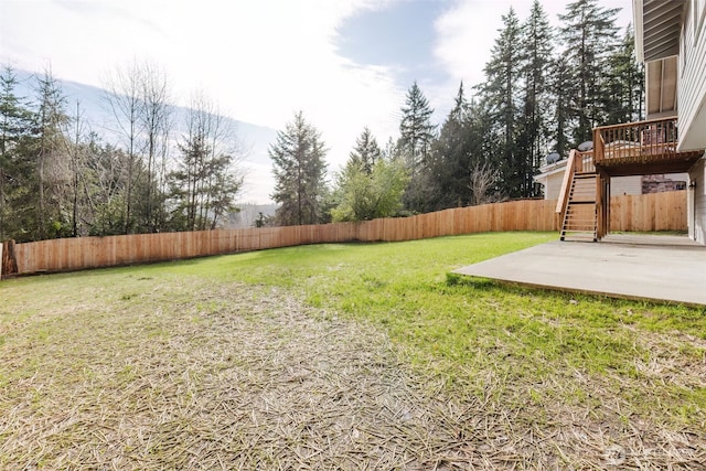 view of yard with a patio, stairway, a fenced backyard, and a wooden deck