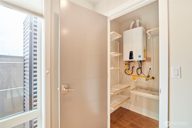 bathroom featuring water heater and wood finished floors