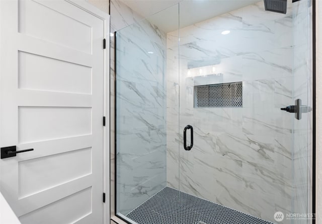 full bath featuring a marble finish shower