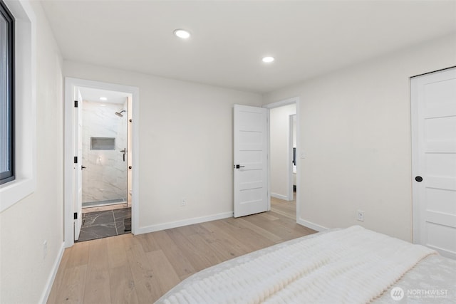 bedroom with recessed lighting, baseboards, light wood finished floors, and ensuite bathroom