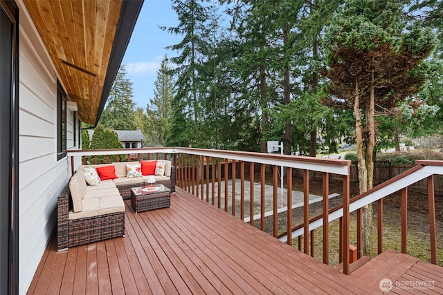 wooden terrace featuring fence and an outdoor living space