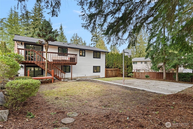 rear view of house featuring stairs, a patio, a deck, and fence