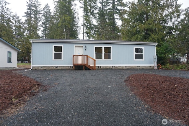 manufactured / mobile home with crawl space and aphalt driveway