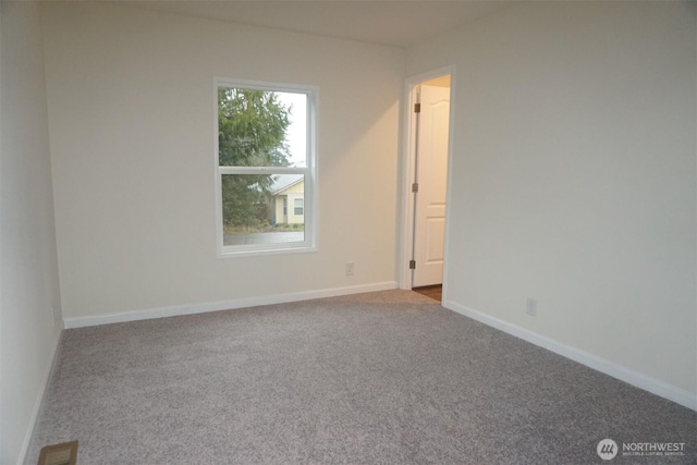 carpeted spare room with baseboards