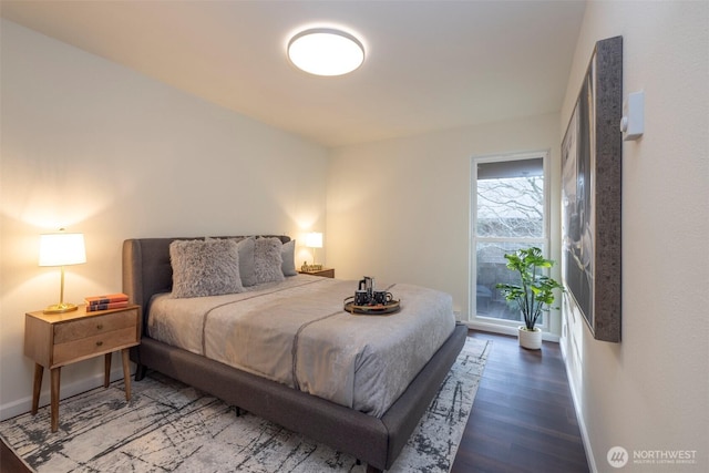 bedroom featuring baseboards and wood finished floors