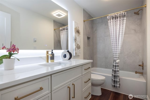 bathroom featuring vanity, shower / bath combination with curtain, toilet, and wood finished floors