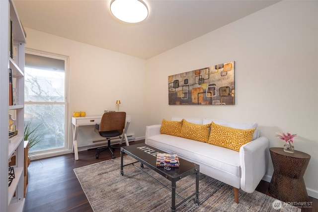 living area featuring dark wood finished floors, baseboards, and a baseboard radiator